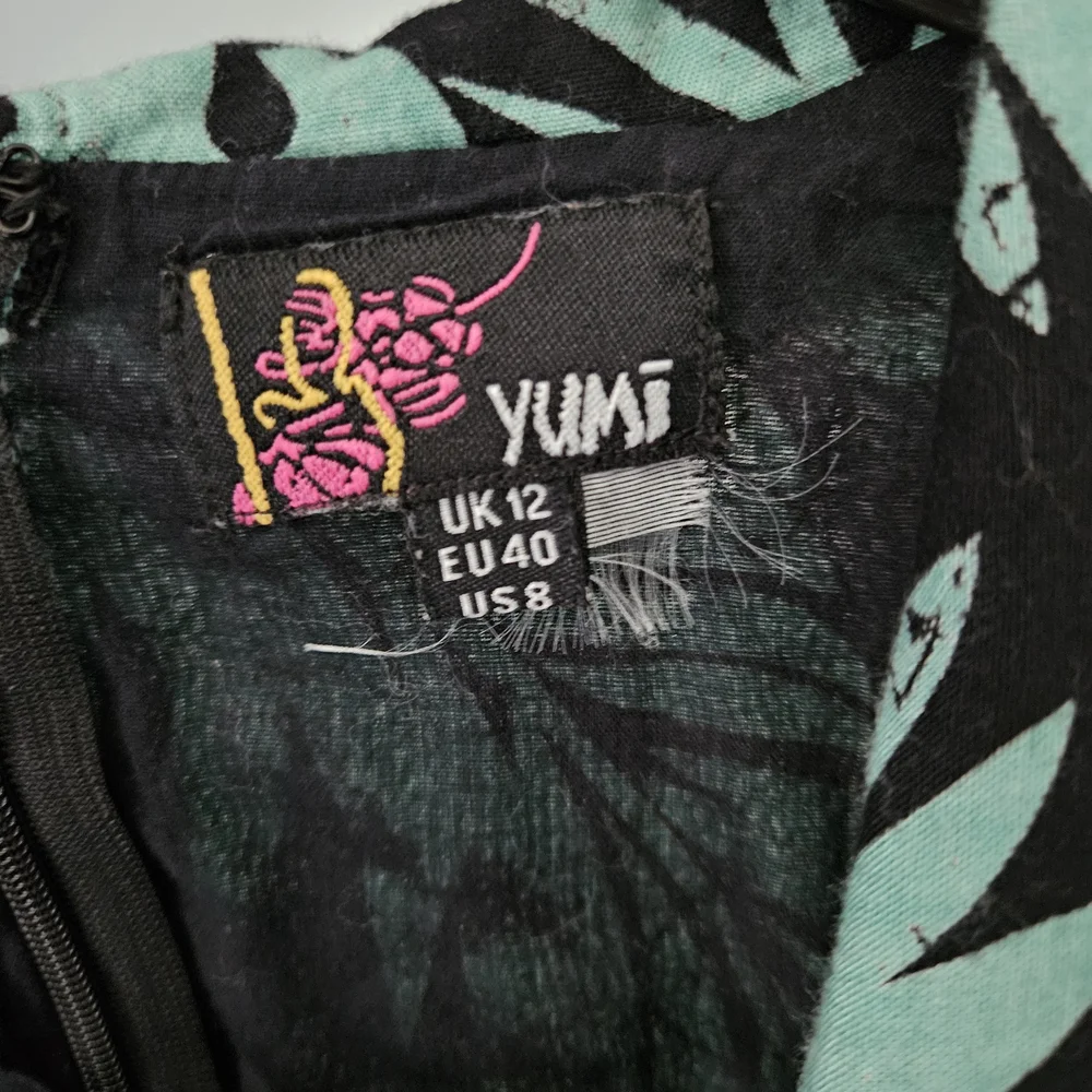 Yumi Black and‎ Teal Leaf Pattern Rompee